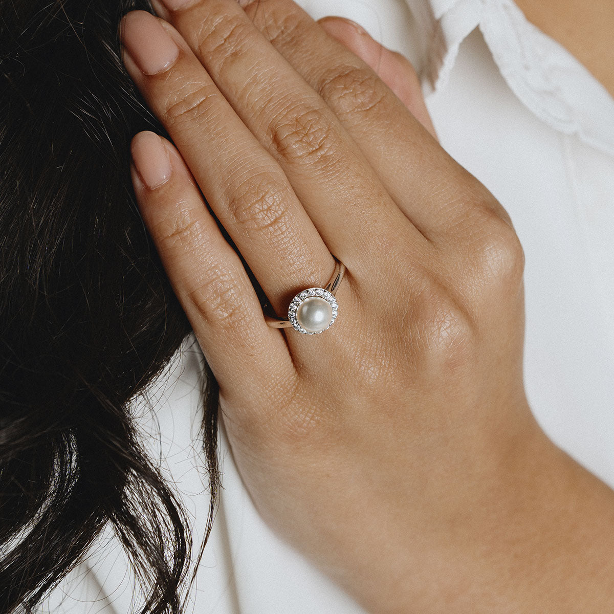 Silver ring with a pearl and white zirconias stones all around