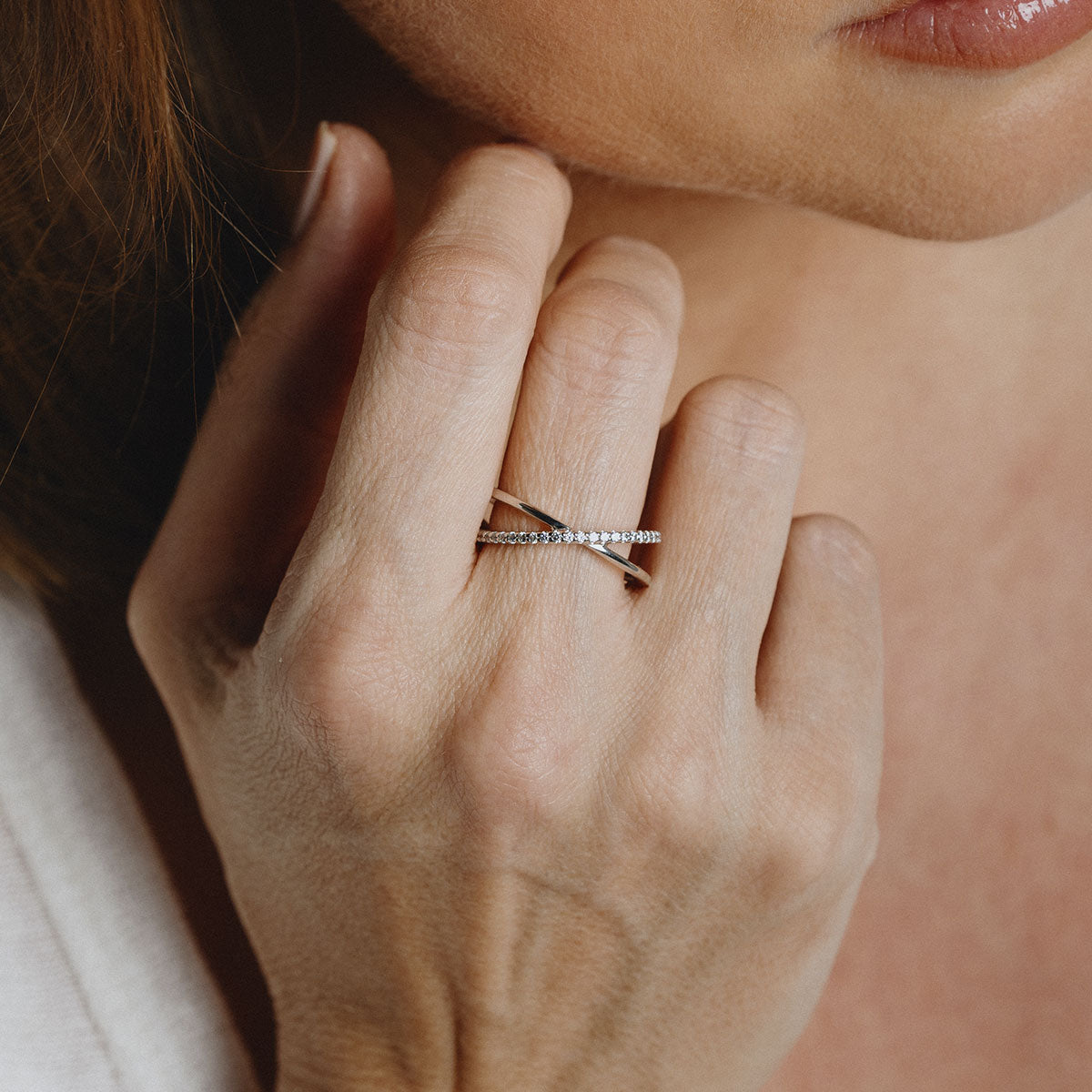 Silver crossed ring with white zirconia stones