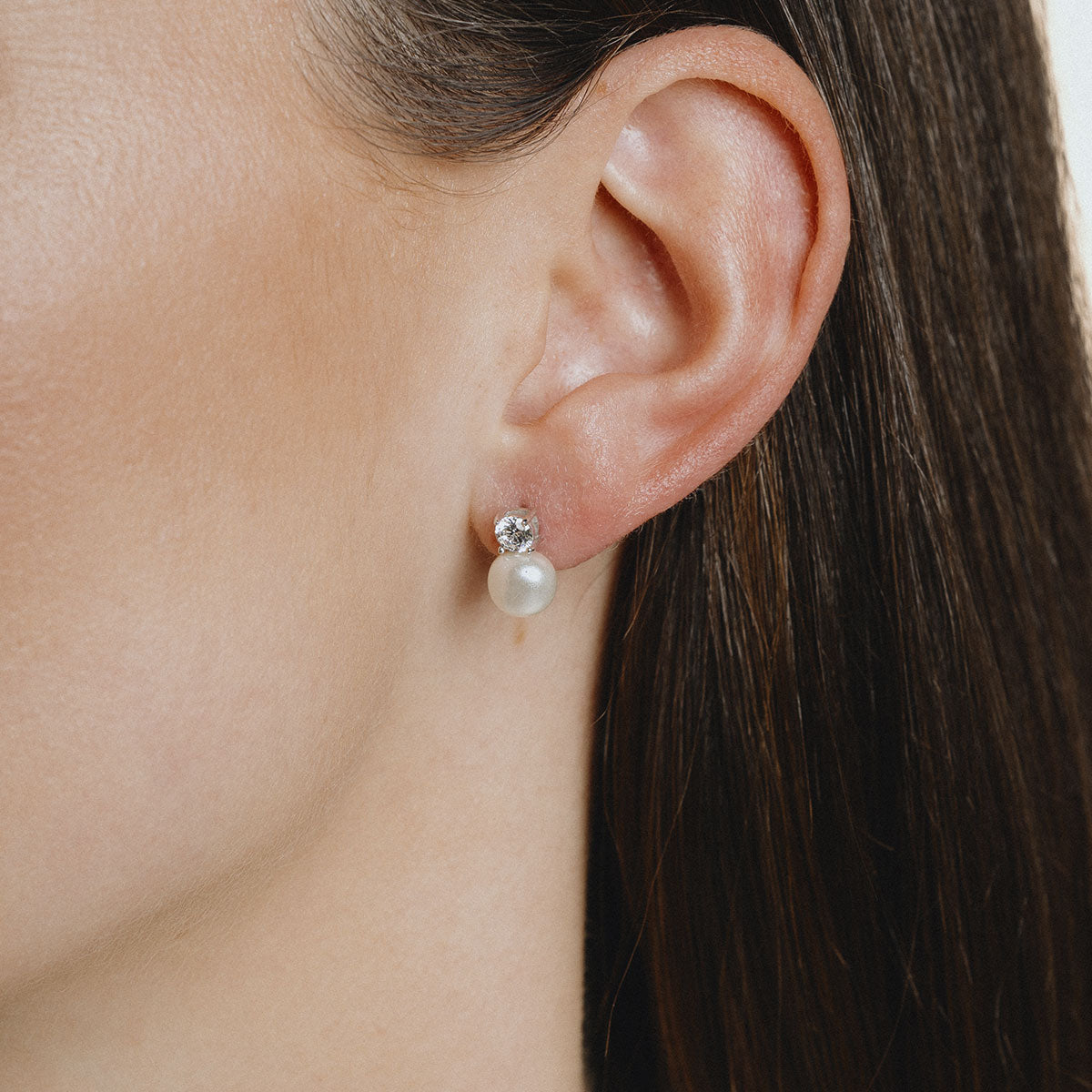 Silver stud earrings with a pearl and white zirconia