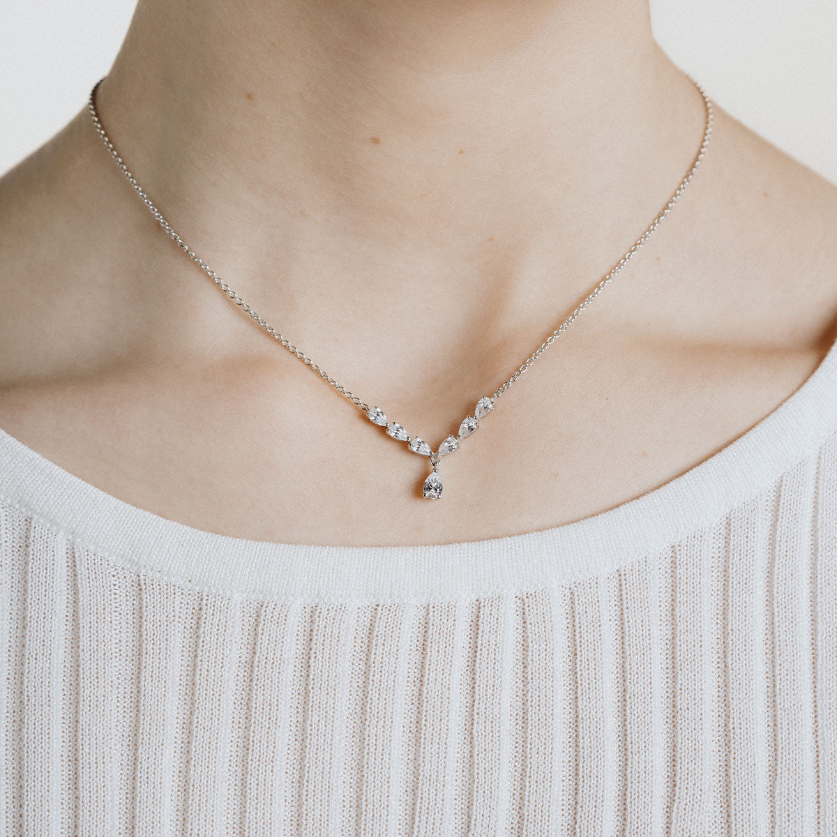 Silver teardrop shaped necklace with white zirconia