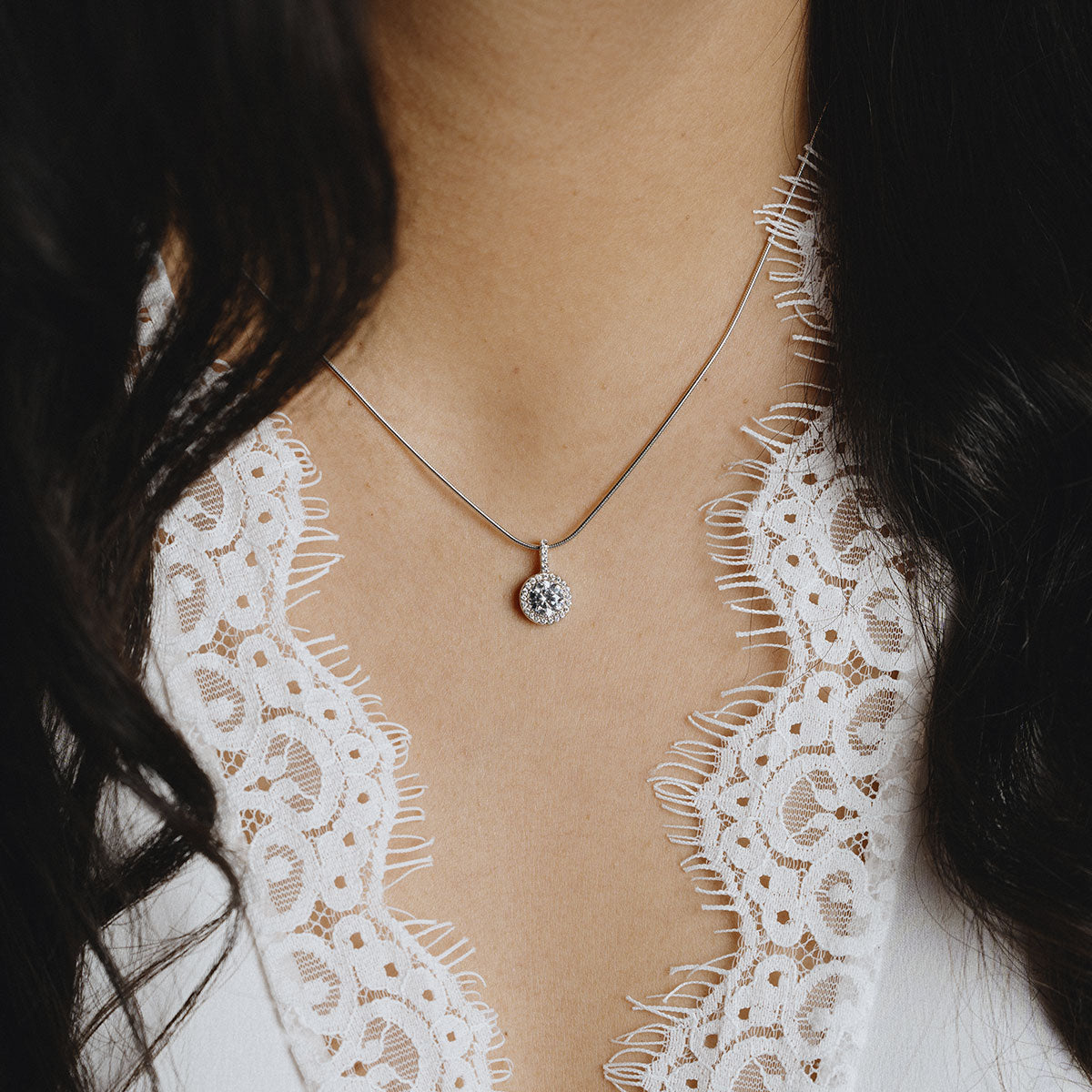 Round silver necklace with white zirconia and pave setting.